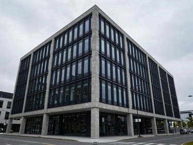 Wide architectural perspective of a modern concrete and glass corporate headquarters, clean lines, cool overcast daylight, deep slate tones, 35mm