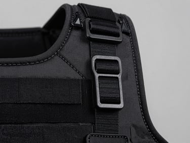 Macro close-up of tactical vest modular webbing, heavy-duty stitching, high-contrast studio lighting, neutral gray background
