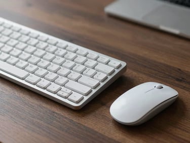 Minimalist silver mechanical keyboard and wireless mouse on a dark oak desk, soft natural side-light, macro shot