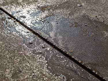 Macro shot of power-washed concrete, showing crisp, clean lines and texture, with water drying in patches, sharp natural light