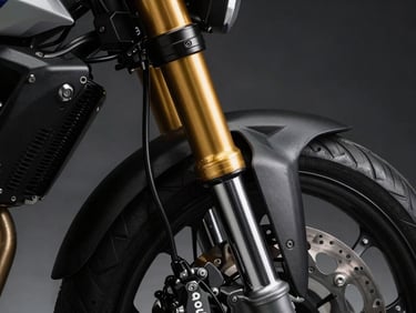 Close-up of a high-end gold anodized motorcycle front fork suspension and Brembo brake caliper, high-contrast shadows