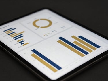 Close-up of a modern executive tablet interface displaying clean financial dashboards, gold and navy blue bar charts, abstract growth metrics, dark sleek background, soft lighting.