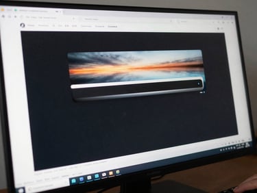 Close-up tight crop under bright daylight from a monitor, an Android UI transition animation frozen mid-frame on a large display — crisp motion-blur on the sliding panel element, the surrounding screen content sharp and color-accurate, a developer's hand barely visible at the keyboard edge in the lower right corner
