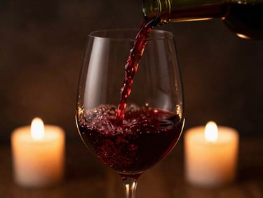 A crystal wine glass being filled with rich red wine, candlelight reflecting in the glass, dark atmospheric background