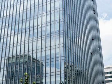 Bright modern Jakarta office building, clean glass facade, natural sunlight, 35mm lens, corporate trust