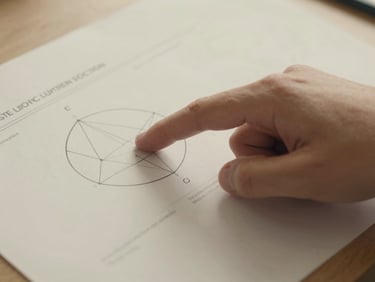 Close-up of a parent's finger pointing to a phase diagram on paper, soft overcast daylight, warm cream tones, detail-focused framing