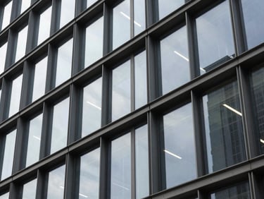 Architectural close-up of structured steel and glass panels, sharp geometric lines, cool indirect daylight.