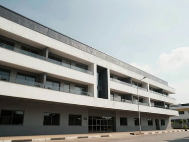 Wide shot of a modern commercial property exterior in Lagos, clean architectural lines, daylight, low-angle framing showing building facade and forecourt, no people
