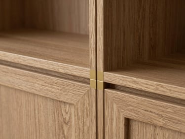 Architectural close-up of custom kitchen cabinetry joint, natural oak grain matching perfectly with a thin gold metal inlay, soft side lighting.
