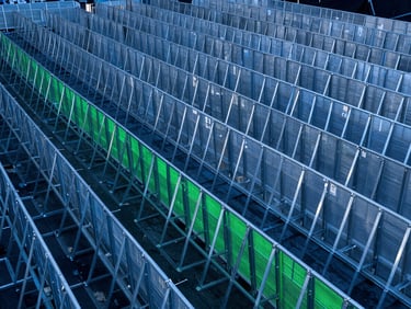 High-volume setup of clean galvanized steel crowd control barriers at a major stadium concert, dramatic dusk lighting, orderly grid layout