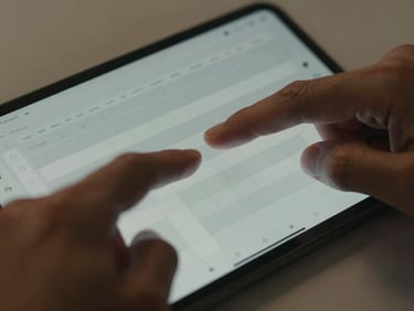 Macro shot of a hand interacting with a physical Android screen showing a highly structured geometric task planner, soft shadows, warm grey tones.