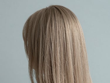 Close-up of soft dimensional hair color reflecting gentle north-facing daylight, showing exceptional strand integrity, 35mm