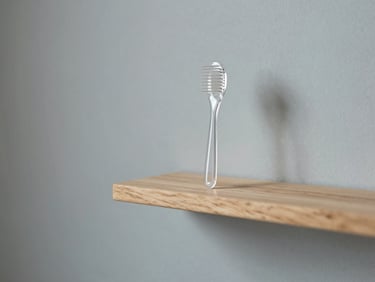 Minimalist clean salon interior with natural light, focusing on a wooden shelf with clear clinical scalp care tools, 35mm