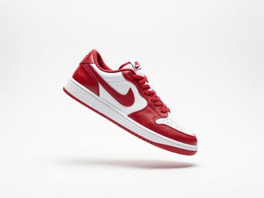 Crisp studio shot of a premium red and white sneaker floating in clean white space, bright studio lighting, soft shadows, sharp focus