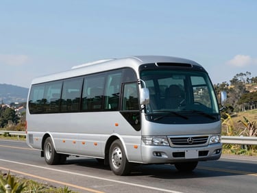 A luxury silver minibus driving on a clear scenic road in the Sabana de Bogotá, bright natural daylight
