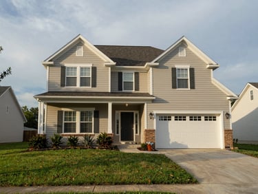 Exterior front facade of a well-kept two-story home in Fayetteville Arkansas shot at true morning light, soft overcast sky, lawn visible in foreground, no color enhancement, accurate proportions showing actual yard and neighboring street context