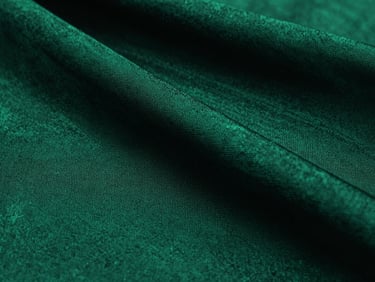 Macro shot of deep emerald green dyed silk fabric, showing intricate weave texture, cinematic lighting