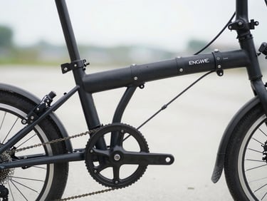 Close-up of a folded black Engwe electric bike showing heavy-duty hinges and fat tires, natural overcast light