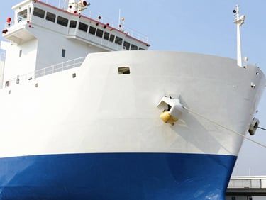 Clean geometric cargo ship docked at a modern terminal, crisp natural daylight, high-key corporate photography, 35mm