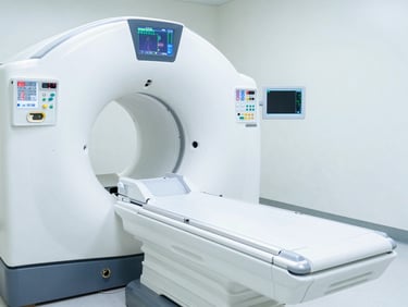 High-end multi-slice CT scanner in a pristine white clinical room, sharp focus on the control interface screen showing organ data