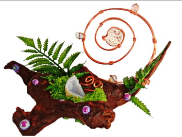 Whimsical crystal sculpture with copper wire spiral, geode, and moss on driftwood.