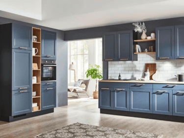 Modern navy blue kitchen cabinets with gold handles and white subway tile backsplash.