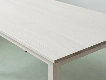 A minimalist oak dining table detail, clean lines, bright daylight, soft shadows