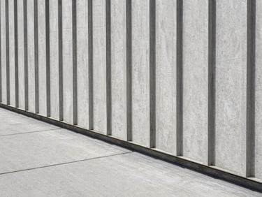 Close-up of premium acoustic wall paneling meeting a polished concrete floor with precision, architectural detail
