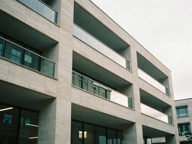 Architectural detail of a modern UK office space, focusing on clean lines and natural light, soft British daylight, muted forest green and stone tones, 35mm film grain.