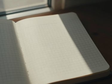 An open notebook with clean editorial grid layouts sketched in black ink, minimal aesthetic.