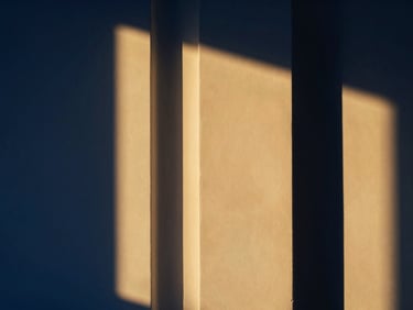An elegant, minimalist interior of a high-end property, bathed in warm golden light, sharp architectural lines