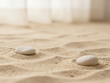 Soft-focus abstract natural texture of warm sand and smooth stone under diffused daylight, cream and beige tones, minimalist composition