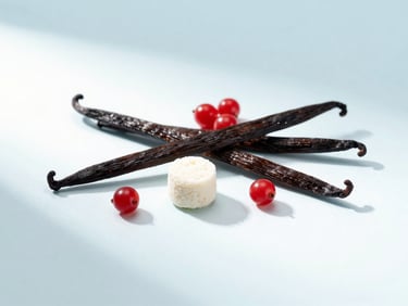 Elegant arrangement of vanilla pods, red berries, and a single collagen scoop on a clean white and pastel blue surface, soft diffused light.