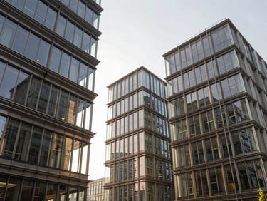 High-contrast architectural photograph of modern office facades, glass reflections, structural steel, bright overcast daylight.