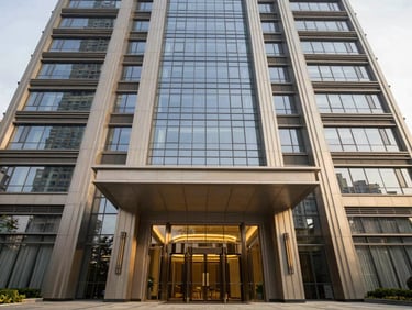 Symmetrical architectural framing of a premium commercial tower entrance, crisp glass and steel finishes, bright overcast daylight