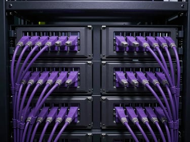 Symmetrical close-up shot of a dark server rack with neat, structured violet fiber optic cabling, low-key dramatic studio lighting