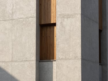 Architectural tower facade with minimalist concrete and warm wood tones, sharp shadows, soft natural daylight, Hasselblad photography