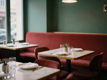 Cozy Scandinavian bistro interior, soft natural light, empty tables set for dinner, warm atmosphere, rich crimson and forest green accents.