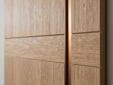 Close-up architectural detail of a smart-home integrated wall panel, seamless engineered wood grain with warm bronze accents, soft natural side-light highlighting physical texture, premium craftsmanship.