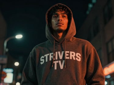 Gritty urban street scene at night, a fan wearing a STRIVERS TV hoodie, dramatic neon backlighting, low-angle heroic shot.