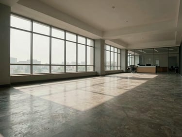 Wide-angle interior of an empty commercial office floor in Vadodara, north-facing window light, polished flooring, no people or furniture