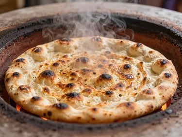 Close-up of blistered, golden-brown Afghan flatbread emerging from a glowing clay tandoor, steam rising, warm editorial food photography, shallow depth of field, 35mm