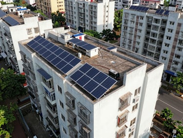 Drone shot of a multi-building cooperative housing society in Wakad with integrated rooftop solar panels.