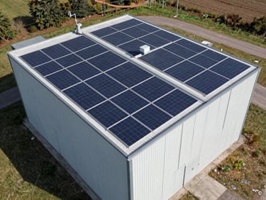 Close-up of high-vis vest engineer inspecting heavy-duty Solis inverters mounted on a clean, professionally wired panel.