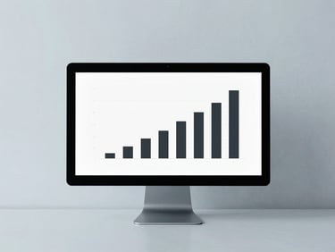 Minimalist clean workspace with a monitor displaying a simple, high-contrast bar chart, diffused overcast lighting.