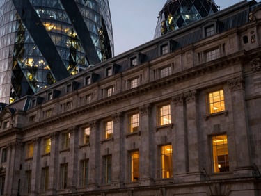 Classic stone architecture of London paired with modern glass facades, soft dramatic twilight lighting.