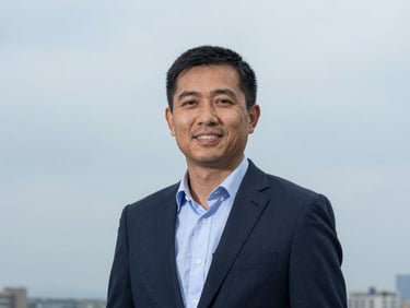 Professional portrait of a board member, mid-shot, natural overcast daylight, respectful, authentic