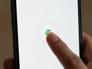 Close-up of a single finger tapping a minimal Android app button on a white phone screen, soft indoor daylight, tight crop showing only the finger and the button