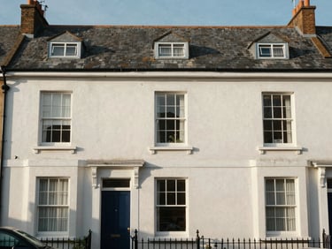 Straight-on architectural shot of a Wirral Victorian terrace exterior, crisp morning daylight, clean lines, slate roof details.