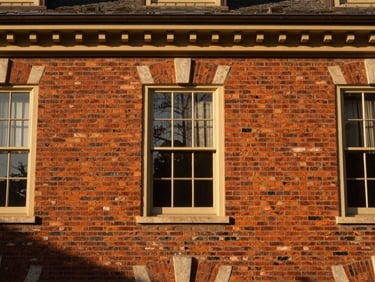 Bespoke architectural detail of a restored 19th-century brick estate in Leesburg, warm golden-hour light